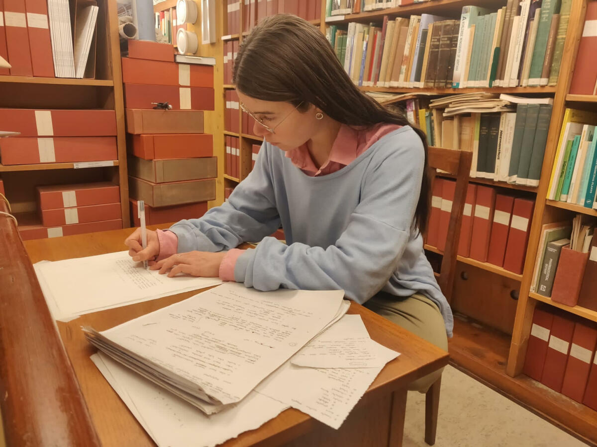 Student writing in an old library